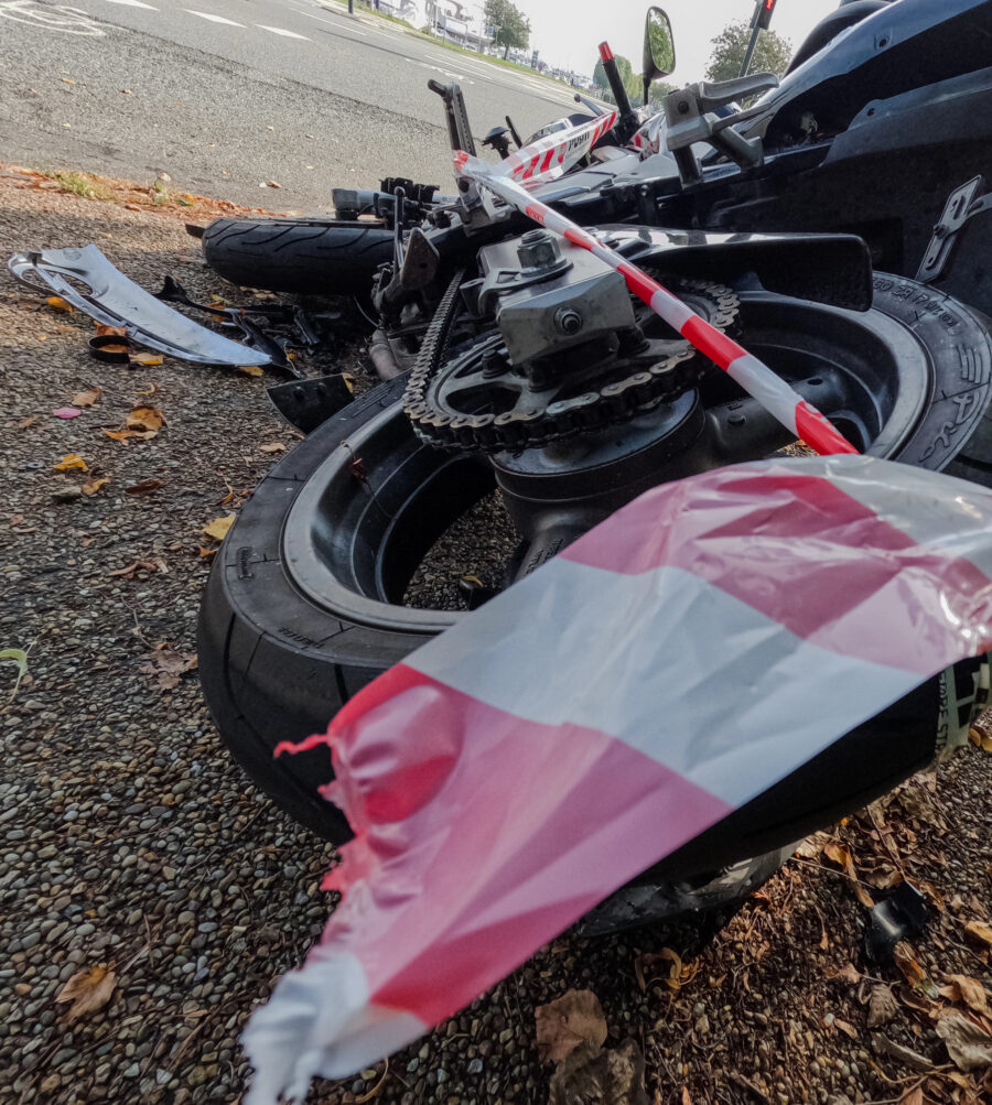 photo of a wrecked motorcycle on a road